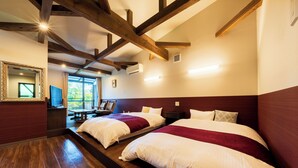 A hotel room with two beds, wooden beams on the ceiling, a large mirror, and a window with a view of greenery. - Yufuin ZEN - Adults Only (Yufu)
