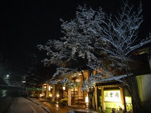 A building with a traditional architectural style, featuring a wooden facade and a sign with Japanese characters.