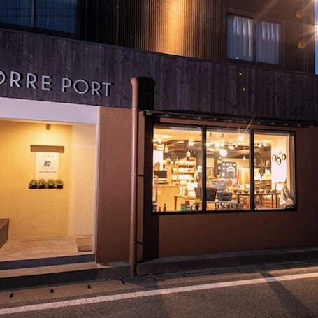 A storefront with the sign "ORRE PORT" and large glass windows displaying various items inside.