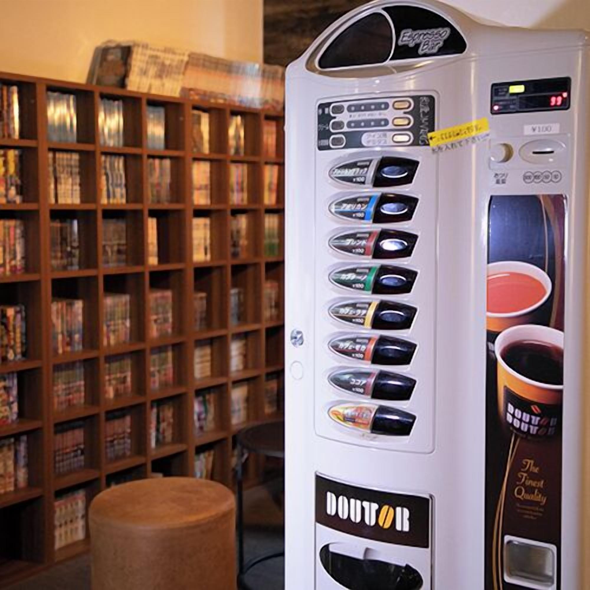 A coffee vending machine with multiple drink options in a library setting.