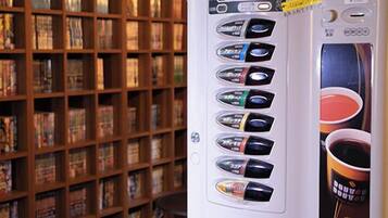 A coffee vending machine with multiple drink options in a library setting.