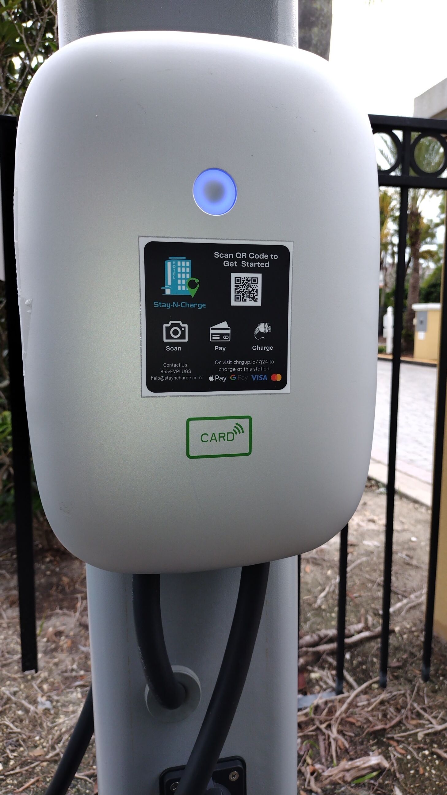 A Stay-N-Charge station with a QR code, contact information, and payment options including Visa.