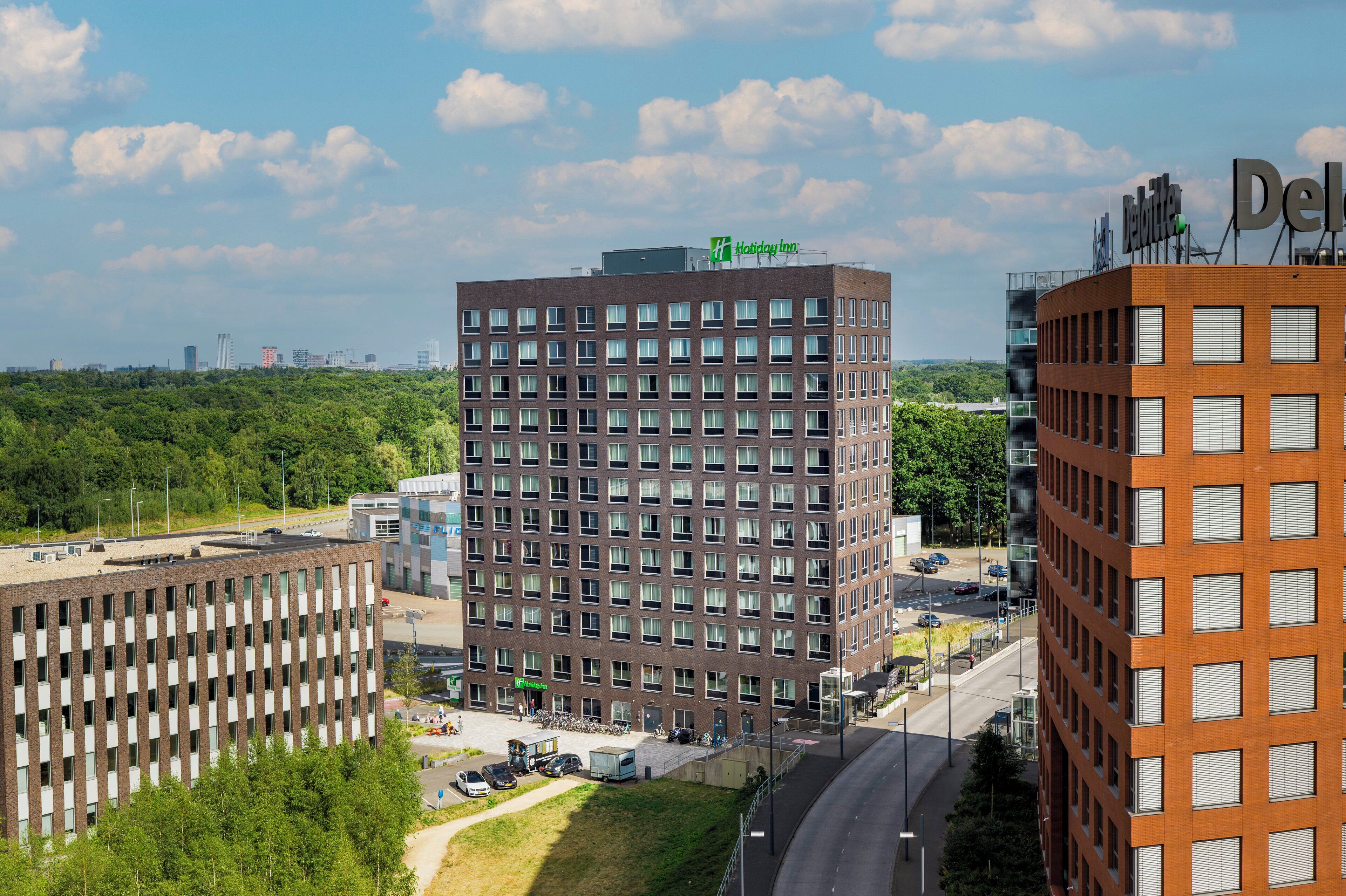 A Holiday Inn Express building with a brick facade, multiple windows, and a flat roof.
