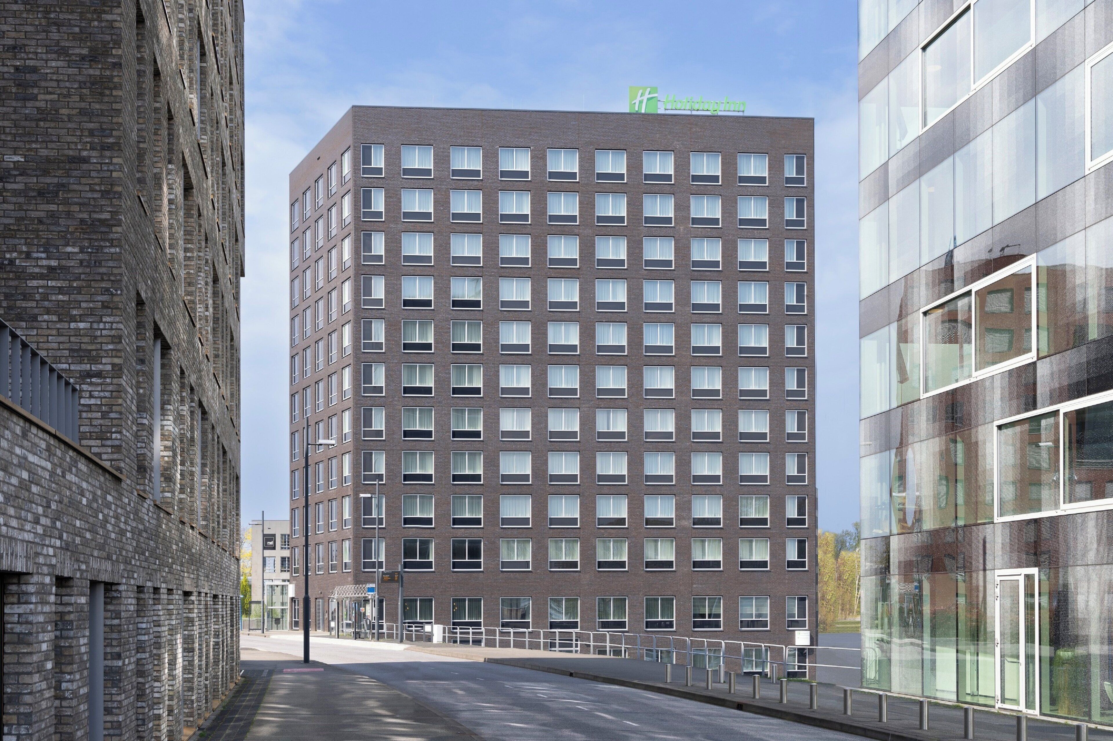 A modern building with a brick facade and multiple windows.