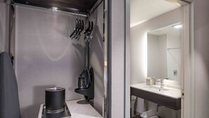 A compact bathroom with a sink, mirror, and towel rack. - Holiday Inn Express Boston South - Quincy by IHG (Quincy)