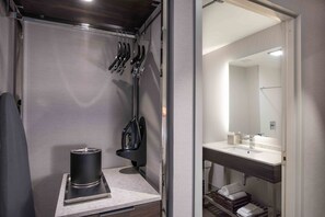 A compact bathroom with a sink, mirror, and towel rack. - Holiday Inn Express Boston South - Quincy by IHG (Quincy)
