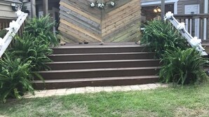 Un escalier en bois mène à un coin agrémenté d’une composition décorative de fleurs blanches.