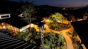 A residential area with houses, a winding pathway, and a mountain in the background. - Takanosho (Aso)