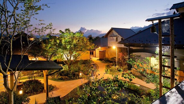 A residential area with houses, a pathway, and a mountainous backdrop. - Takanosho (Aso)