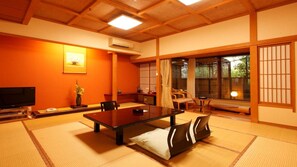 A traditional Japanese room with tatami flooring, a low table, and sliding doors. - Yuyado Mikan No Ki (Atami)