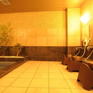 A spa area with tiled floors, a brick wall, and a small pool.