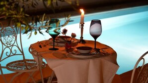 A table set for a meal with a candle, a glass, and a bowl. - B&B Rita and Family (Loceri)