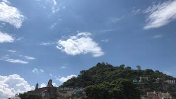 A hillside town with buildings and a prominent church on a hill.