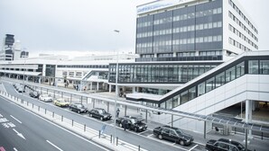 A modern building with a glass facade, multiple floors, and a prominent entrance area with a covered walkway. - Osaka Airterminal Hotel (Toyonaka)