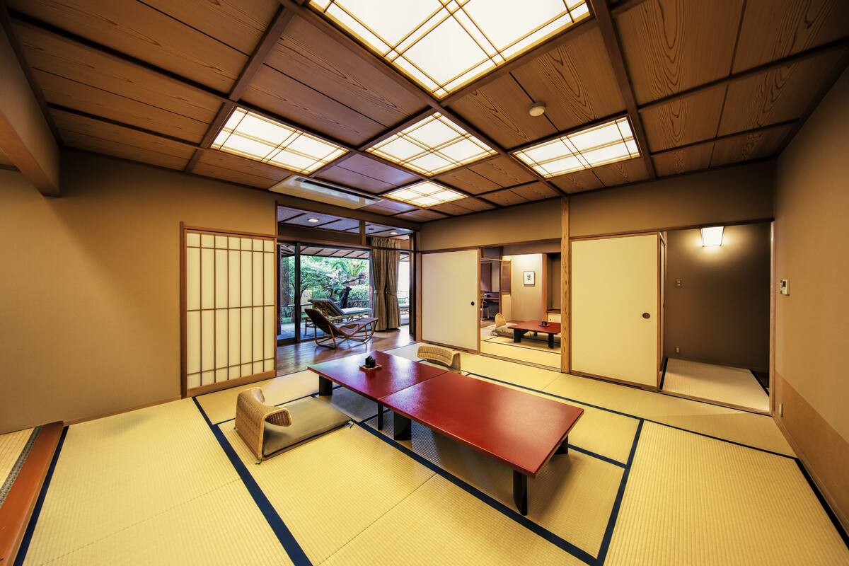 A traditional Japanese room with tatami flooring, a low wooden table, and sliding doors.