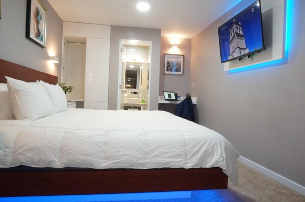 Desk, laptop workspace, blackout drapes, iron/ironing board