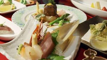 A table with various dishes, including seafood and vegetables, arranged on plates.