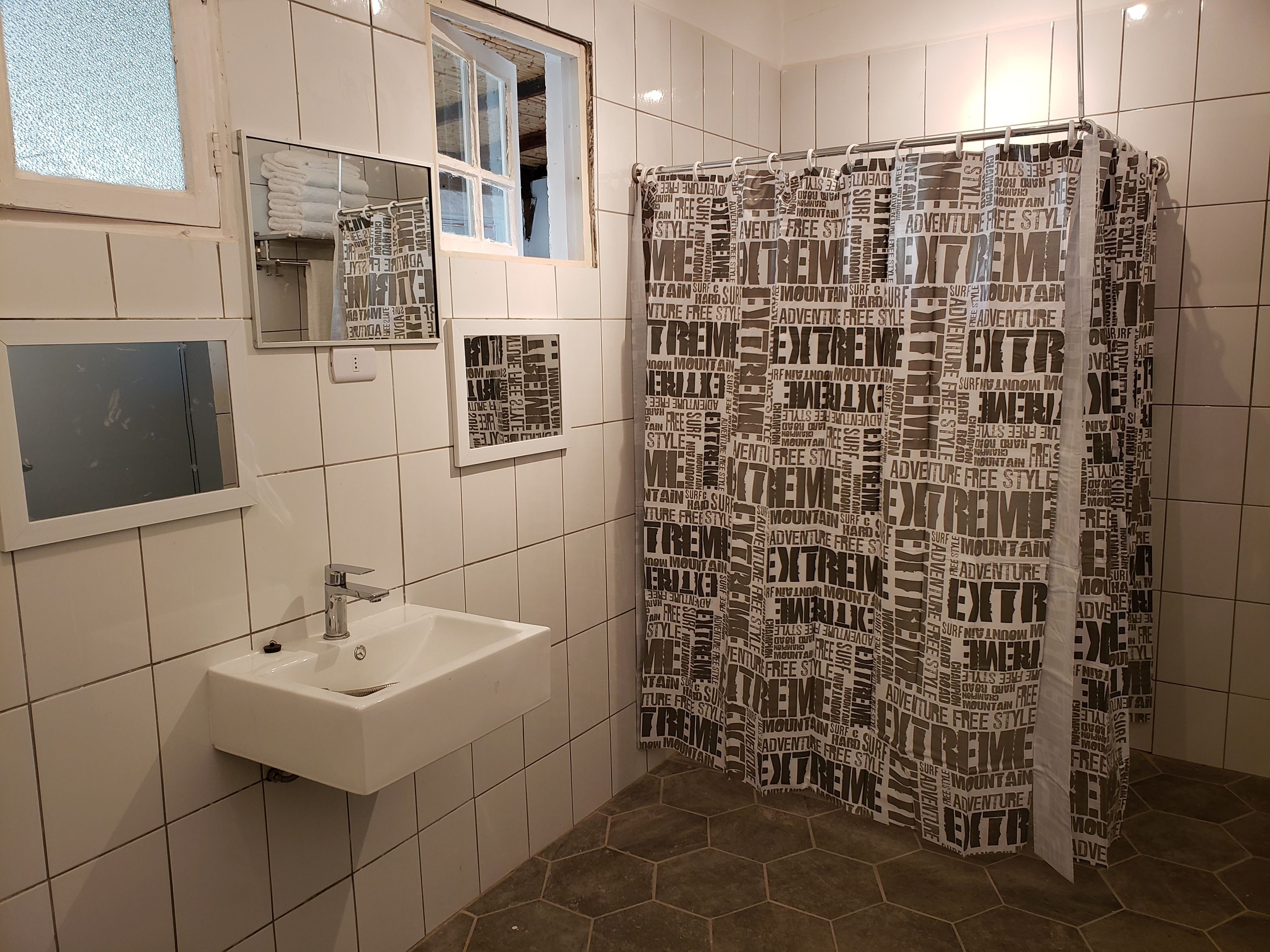 family room | bathroom | combined shower/bathtub, rainfall showerhead, free toiletries, bathrobes