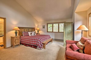 A bedroom with a bed, two bedside tables, a bench, a couch, and a window with a view of greenery. - Walk to Lift: Townhome w/ Shuttle in Breckenridge! (Breckenridge)