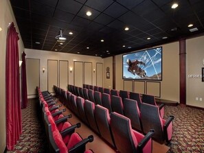 Suitable for meetings and presentations, this room features a large screen and comfortable seating for groups.