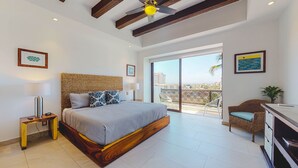 A spacious bedroom with a large bed, a balcony with a view, and a modern ceiling fan. - Extraordinary condo in Urban complex! 2BD Condo for rent in Old Town, Puerto val (Puerto Vallarta)