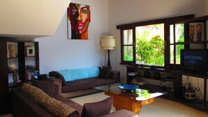 A living room with a sofa, coffee table, and a TV.