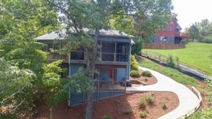 A two-story house with a porch and a fenced yard.