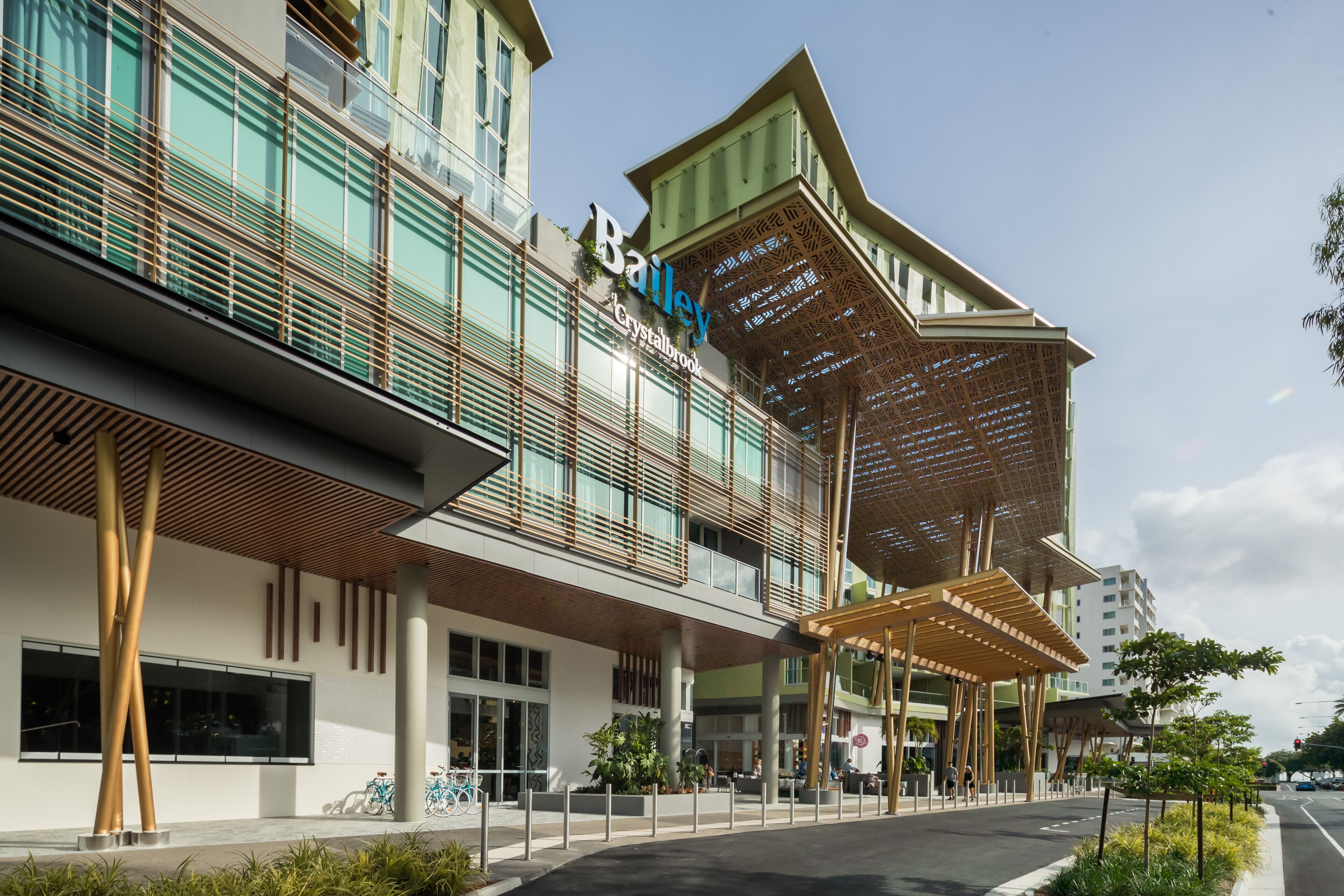 A modern building with a prominent 'Bailey' sign, featuring a unique architectural design with a sloped roof and wooden beams.