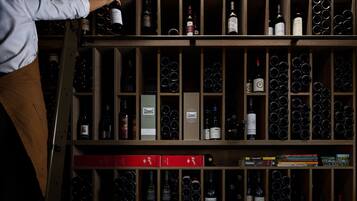 A wine cellar with shelves of wine bottles and boxes.