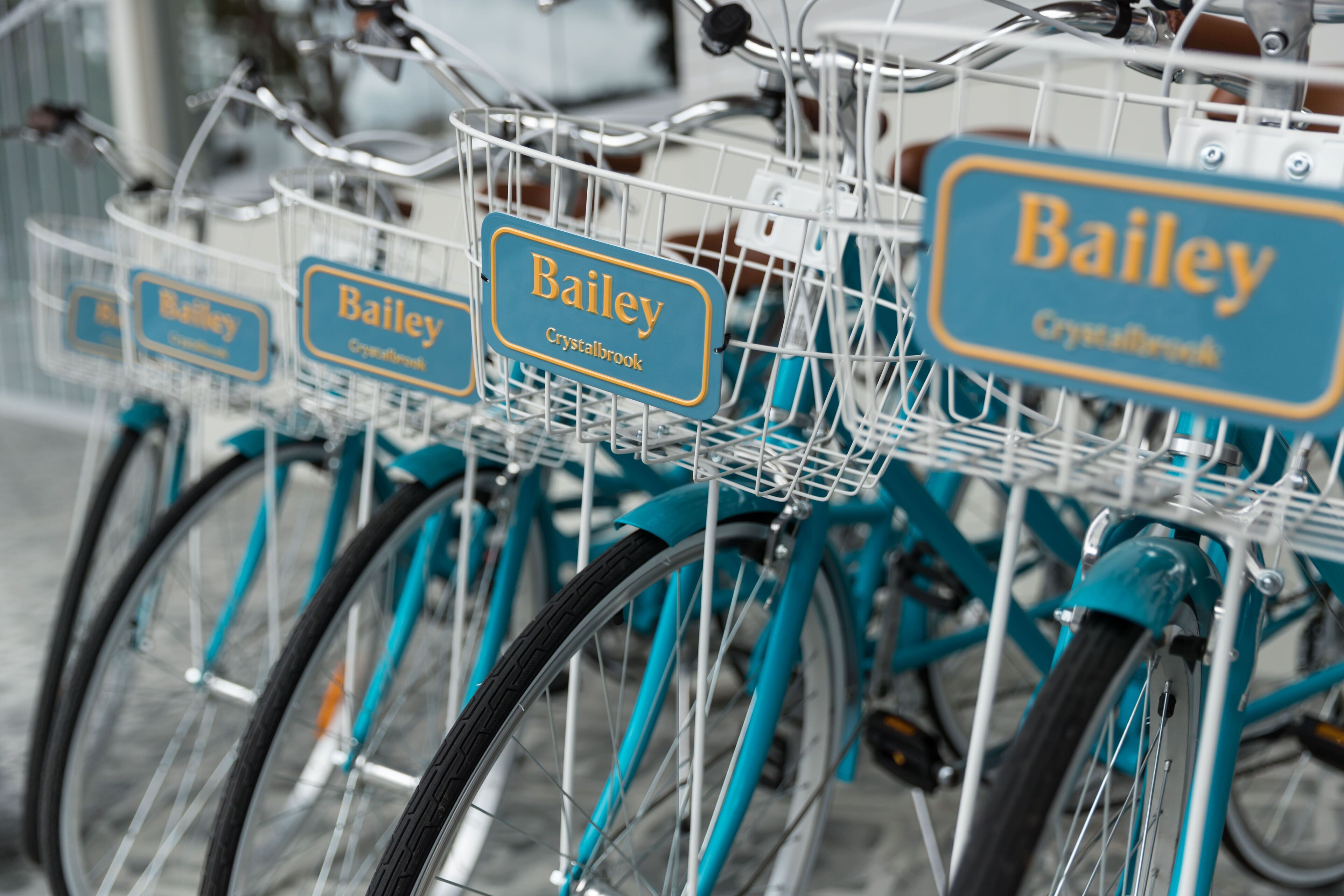 A row of bicycles with name tags.