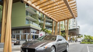 A modern building with a grey car parked in front. - Crystalbrook Bailey (Cairns)