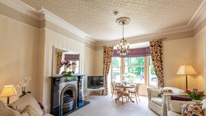 A spacious living room with a fireplace, a dining area, and a comfortable seating arrangement.
