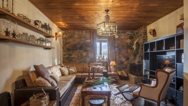 A cozy living room with a wooden ceiling, a stone wall, a fireplace, a sofa, a coffee table, and a bookshelf. - Dandy Villas Palios Agios Athanasios |Rustic | Fireplace | Up to 6 (Agios Athanasios)