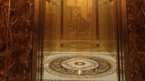 An elevator with a marble wall and a patterned floor. - Bukchon Da Lat Hotel (Xuan Huong - Da Lat)