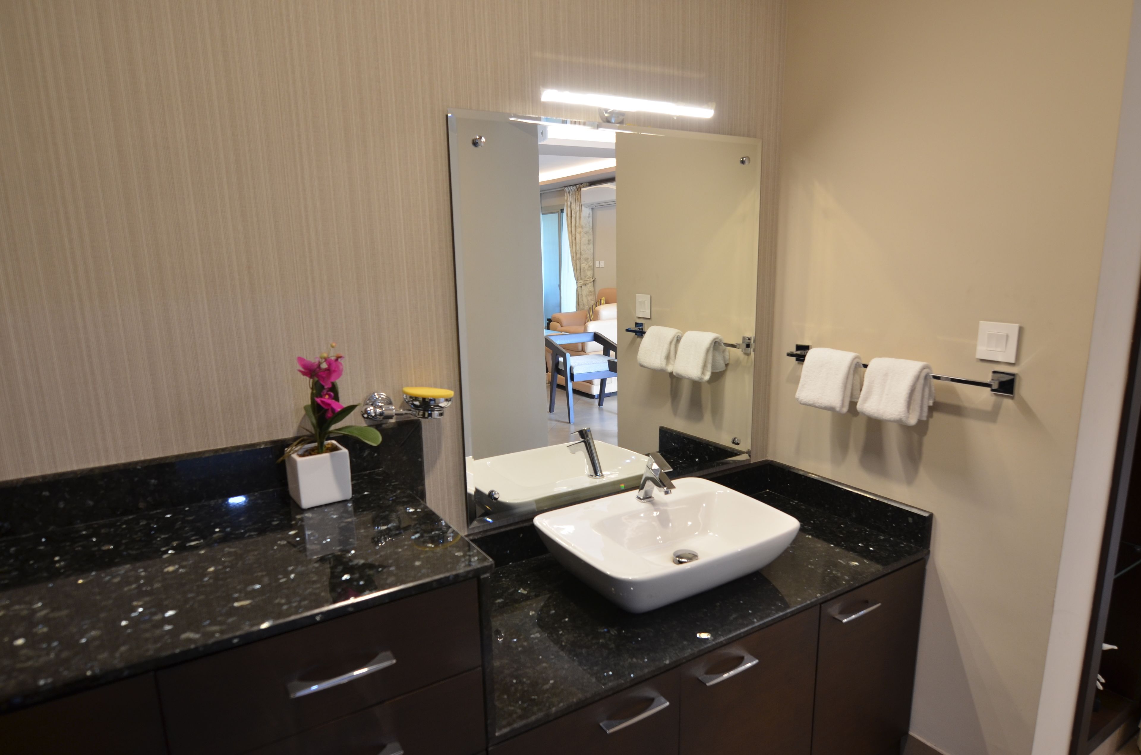 shower, hair dryer, slippers, towels