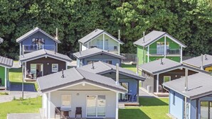 A row of small, single-story cabins with flat roofs, each featuring a balcony and a small porch area. - Amazing home in Thale with sauna (Thale)