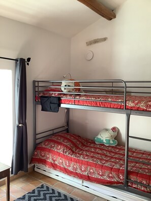 A bunk bed room with a red patterned bedspread, a small dog plush toy, and a black jacket hanging on the side. - Accommodation in Drôme provençale in an 18th century farmhouse with swimming pool (Tulette)