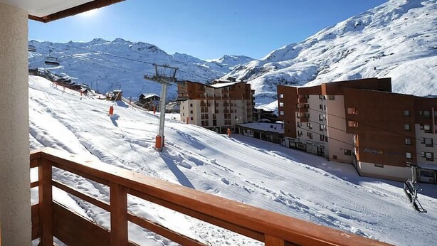 A snow-covered ski slope with buildings and a ski lift in the background. - 3rd floor, view ski slopes/mountain/ski slopes, balcony, tv, ski locker, 25m², Les Menuires (Les Menuires)