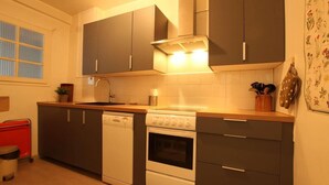 A compact kitchen with grey cabinets, a dishwasher, an oven, and a stove. - 350m from ski slopes, 1st floor, terrace, parking, tv, 56m², Serre Chevalier (SERRE CHEVALIER)