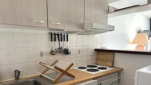 A compact kitchen with a sink, stove, and oven.