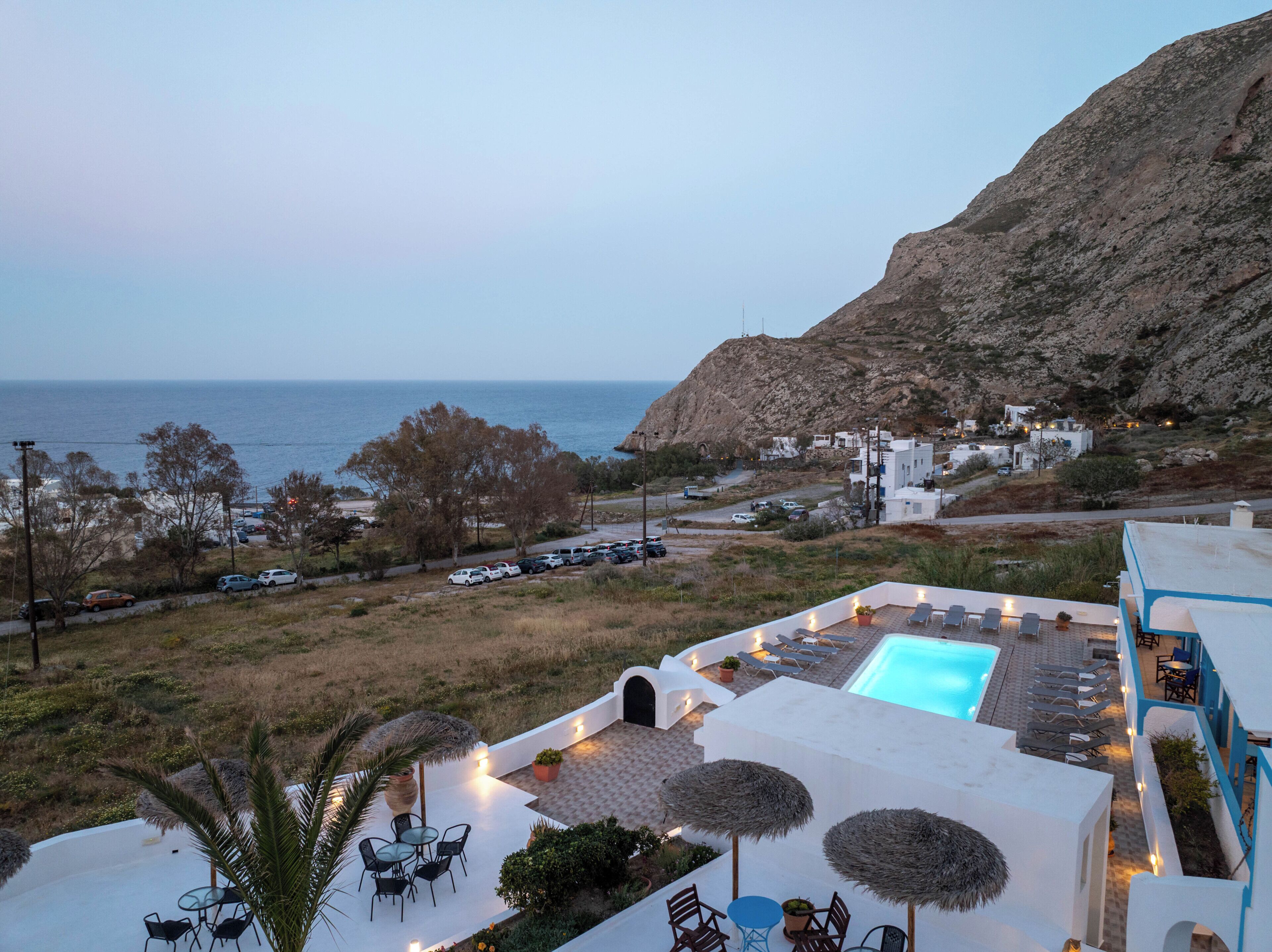 Ein Resort mit Pool, Sitzgelegenheiten im Freien und Meerblick.