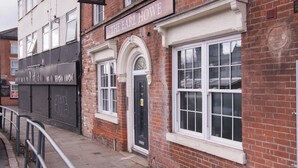 A brick building with a sign reading "The Earl Howe." - Arena Apartments (Nottingham)