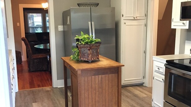 A kitchen with a wooden island, stainless steel appliances, and a view to a dining area. - Back to School Special! 5 minutes from Majestic Baseball Fields (Hot Springs)