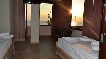 Deluxe Triple Room, Sea View | Pillowtop beds, individually decorated, individually furnished, desk