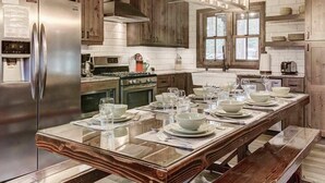 A modern kitchen with a central island, stainless steel appliances, and wooden cabinetry. - Heavenly Hideaway 4BR,4BA, Hot Tub (South Lake Tahoe)