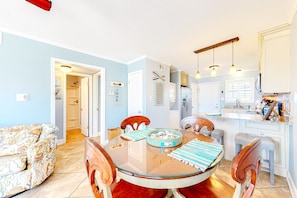 Relax in this stylish living and dining area with a large round table and comfortable seating.