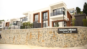 A modern building with a stone facade and a sign reading "Sawsana Villalani". - Sawsana Villalari (Sapanca)
