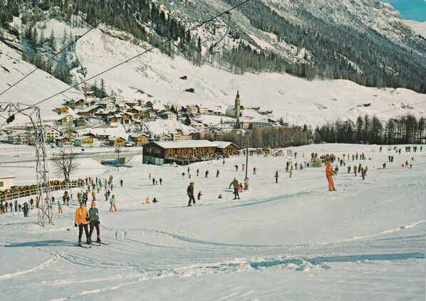 A ski resort with multiple buildings, a ski lift, and a snowy landscape. - Hotel Bodenhaus (Rheinwald)