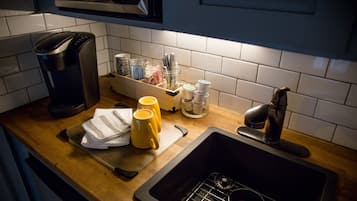 Fridge, microwave, coffee/tea maker, cookware/dishes/utensils