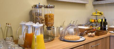 A breakfast buffet with various food items and beverages.